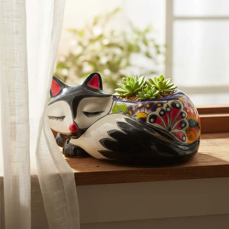 The Talavera Hub sleeping fox planter, hand-painted ceramic with vibrant floral patterns in blue, red, yellow, and green.
