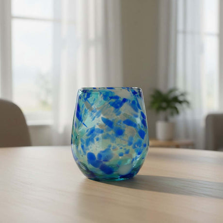 The Talavera Hub hand-blown stemless wine glass with white and blue snow design, 12 oz capacity.
