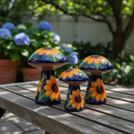 The Talavera Hub set of 3 ceramic mushrooms hand-painted with sunflowers and blue glaze. Small decorative art.