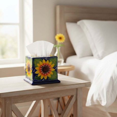 The Talavera Hub square tissue box cover with hand-painted yellow sunflower design on a blue ceramic base.