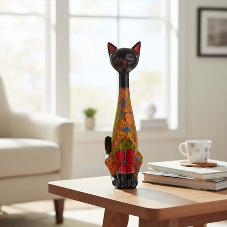 The Talavera Hub tall cat statue with black head and vibrant floral terracotta body on a wooden table