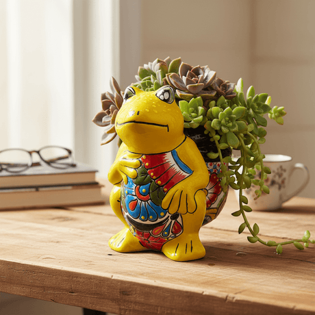 The Talavera Hub yellow ceramic frog planter with hand-painted colorful floral design on belly.