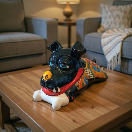 The Talavera Hub black ceramic dog decor with bone, hand-painted with vibrant blue eyes and colorful body details.