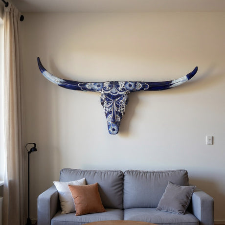 The Talavera Hub blue and white ceramic longhorn skull wall art with intricate floral and geometric patterns.