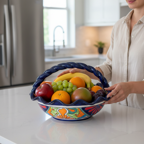 The Talavera Hub colorful hand-painted ceramic fruit basket with a braided blue rim and intricate floral designs.