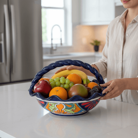 The Talavera Hub colorful hand-painted ceramic fruit basket with a braided blue rim and intricate floral designs.