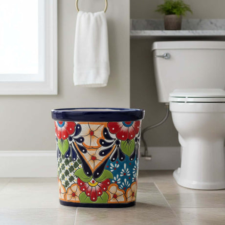 The Talavera Hub handmade ceramic oval trash can with vibrant floral and geometric Talavera designs in red, orange, blue, and green.