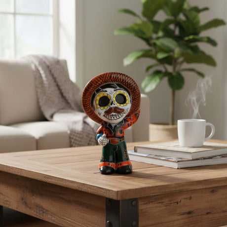 The Talavera Hub hand-painted ceramic skeleton man figurine with sombrero, Day of the Dead decor.