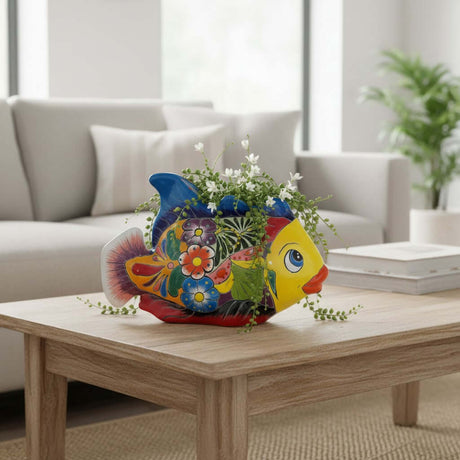 The Talavera Hub hand-painted Talavera fish planter in ceramic. Features a yellow face, blue fins, and floral motifs. 10.5" long.