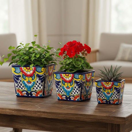 The Talavera Hub set of 3 hand-painted square Talavera planters with colorful floral designs in blue, yellow, red, and green.