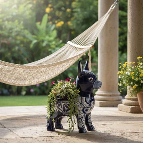 The Talavera Hub large blue and white ceramic donkey planter with hand-painted floral designs. Features two openings for plants.