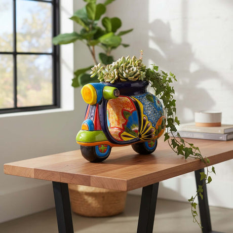 The Talavera Hub large ceramic scooter planter, hand-painted with vibrant floral designs in blue, orange, yellow, green, and red.