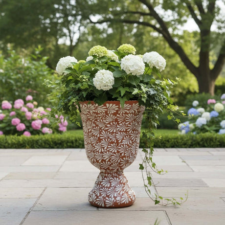 The Talavera Hub XL brown and white ceramic pedestal planter with floral motif. Handcrafted in Mexico, ideal for gardens and