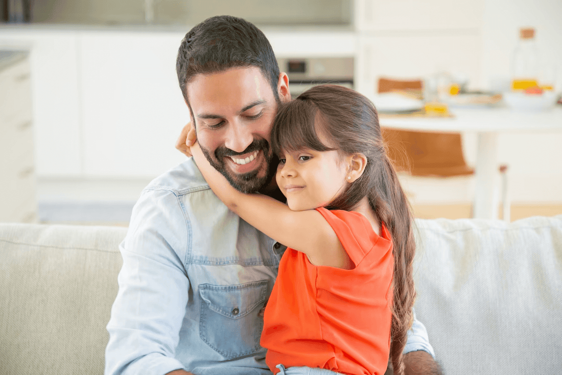 A Mexican father and his child sitting together happily. 