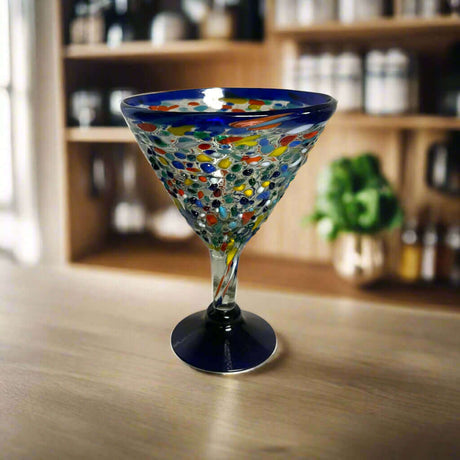 Confetti Rock Martini Glass with Blue Rim | Hand-Blown Mexican Barware - hand-blown pebble martini glass with blue rim on wooden bar