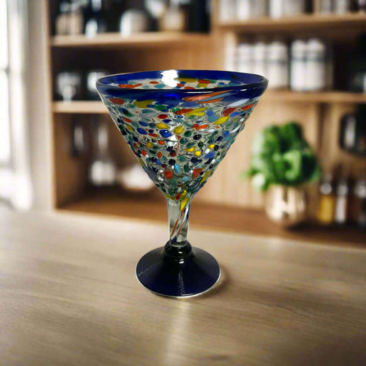 Confetti Rock Martini Glass with Blue Rim | Hand-Blown Mexican Barware - hand-blown pebble martini glass with blue rim on wooden bar