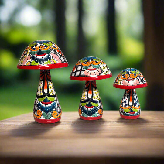 Talavera Mushroom Statue Set | Hand-Painted Mexican Garden Decor - three colorful hand-painted Talavera mushroom statues on wooden table