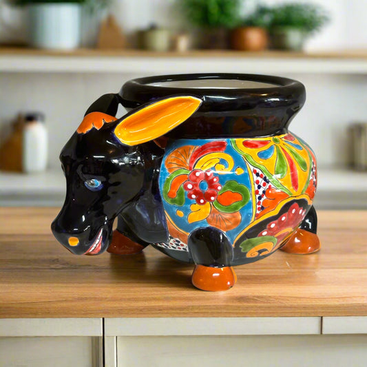 Colorful ceramic bull-shaped pot on a white background