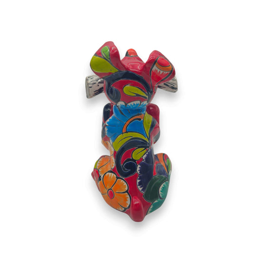 Talavera Dog Holding Newspaper Statue | Colorful Mexican Garden Art - hand-painted red ceramic dog with blue, yellow & green floral motifs