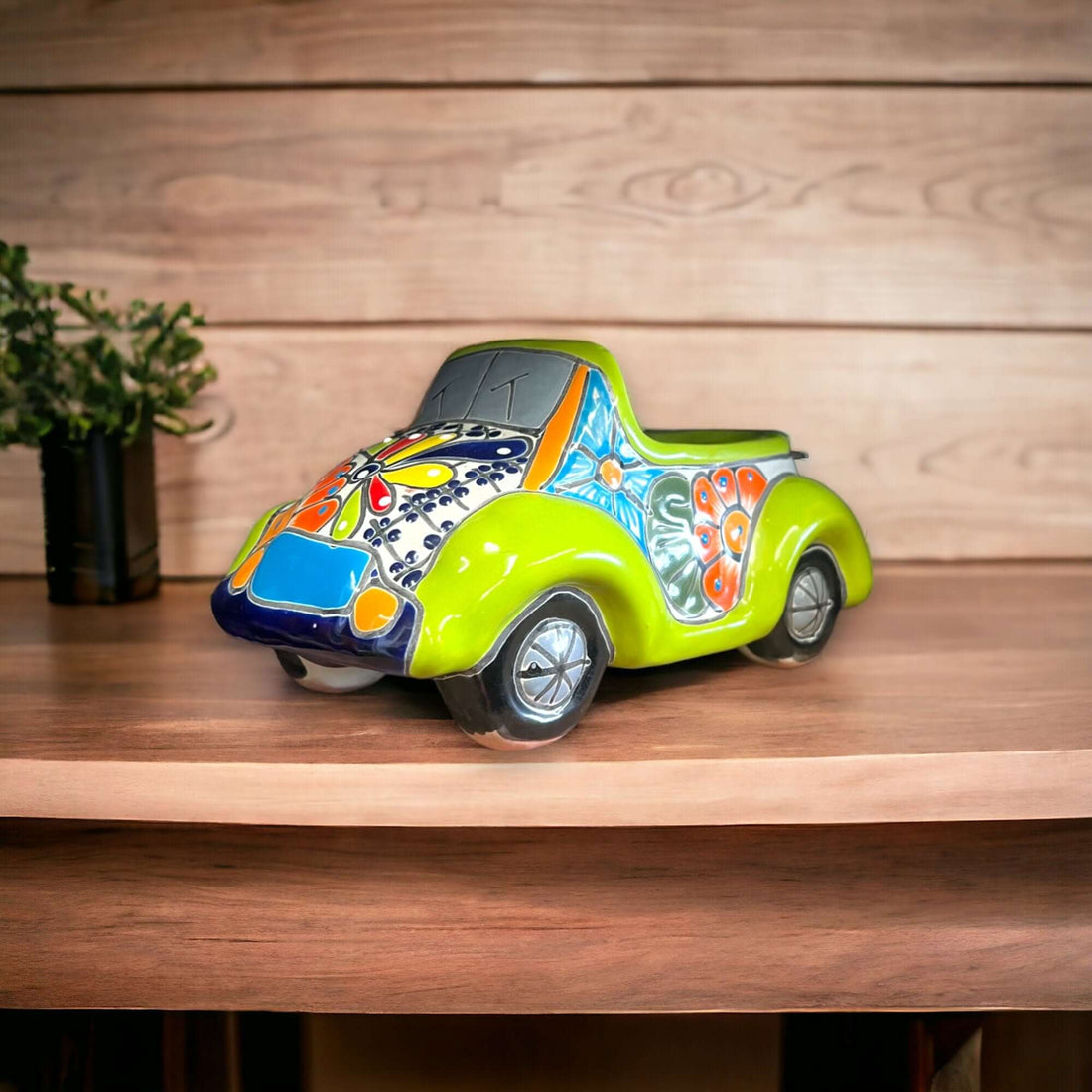 Colorful Hand-Painted Talavera Car Planter | Small Ceramic Car Statue - small lime green hand-painted Talavera ceramic car planter on wooden shelf