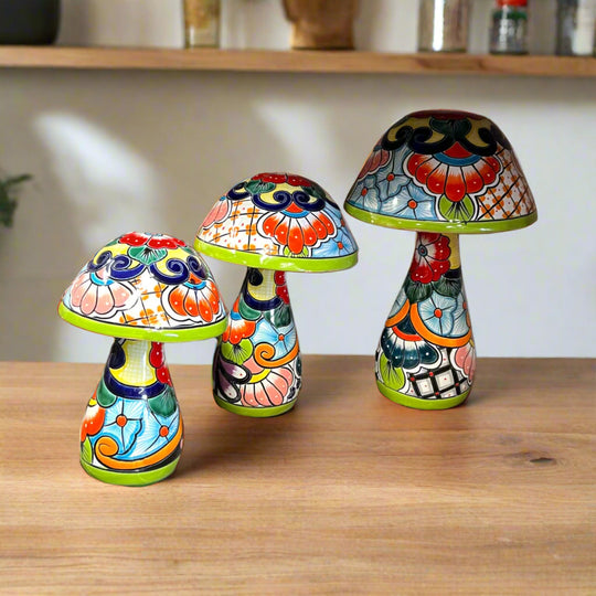 Talavera Mushroom Statue Set | Hand-Painted Mexican Garden Decor three multicolor hand-painted ceramic mushrooms on wooden table