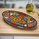 XL Oval Talavera Platter | Hand-Painted Mexican Serving Dish with vivid multicolor floral and geometric motifs, deep blue rim, handcrafted in Guanajuato