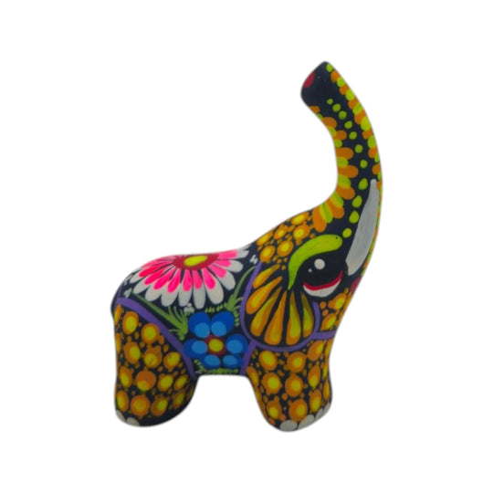 Colorful ceramic Alebrije elephant figurine on a white background