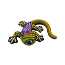 Side view of a colorful ceramic Alebrije lizard figurine showing its curled tail