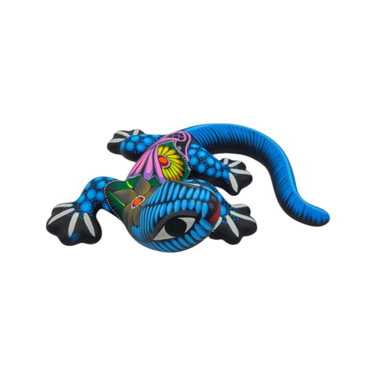 Blue and multicolor ceramic Alebrije lizard figurine on a white background