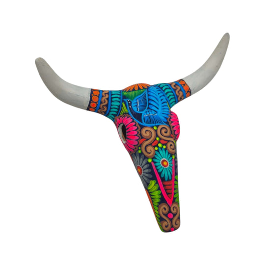 Front view of colorful Mexican bull skull wall art with sweeping pale horns