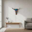Alebrije longhorn wall art displayed above a wooden console in a bright living room