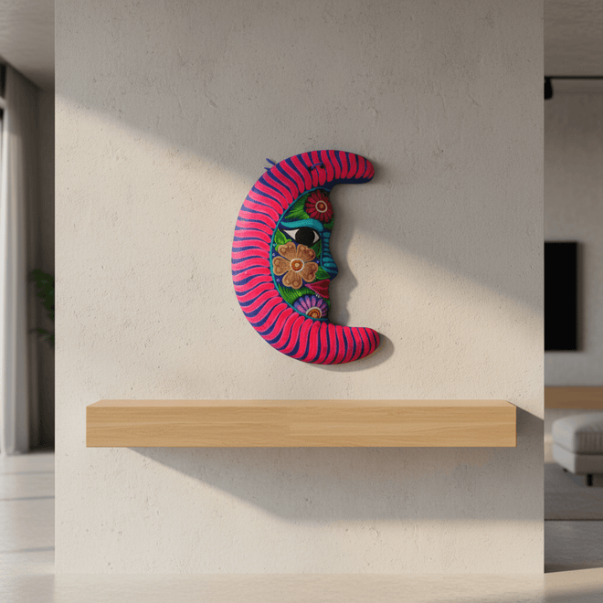 Alebrije moon wall art with floral details displayed above a wooden shelf