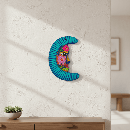 Hand-painted Alebrije moon wall art displayed above a console with a plant