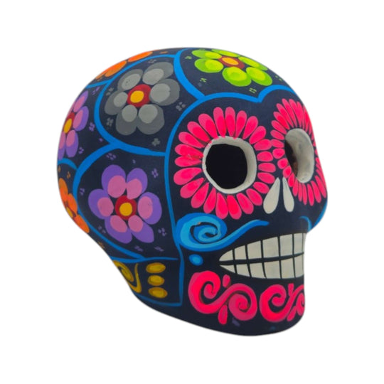 Front view of a blue ceramic Alebrije sugar skull figurine with bright floral details