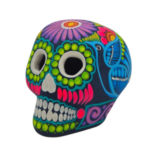 Side detail of a hand-painted ceramic Alebrije sugar skull with colorful flowers