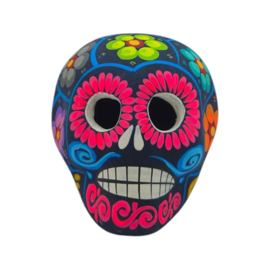Front-facing blue Alebrije sugar skull figurine with pink flowers and painted teeth