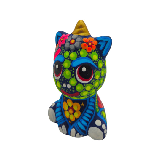 Front view of a blue Alebrije unicorn figurine with colorful floral patterns