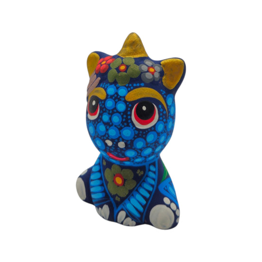 Side view of a blue Alebrije unicorn figurine with hand-painted folk-art details