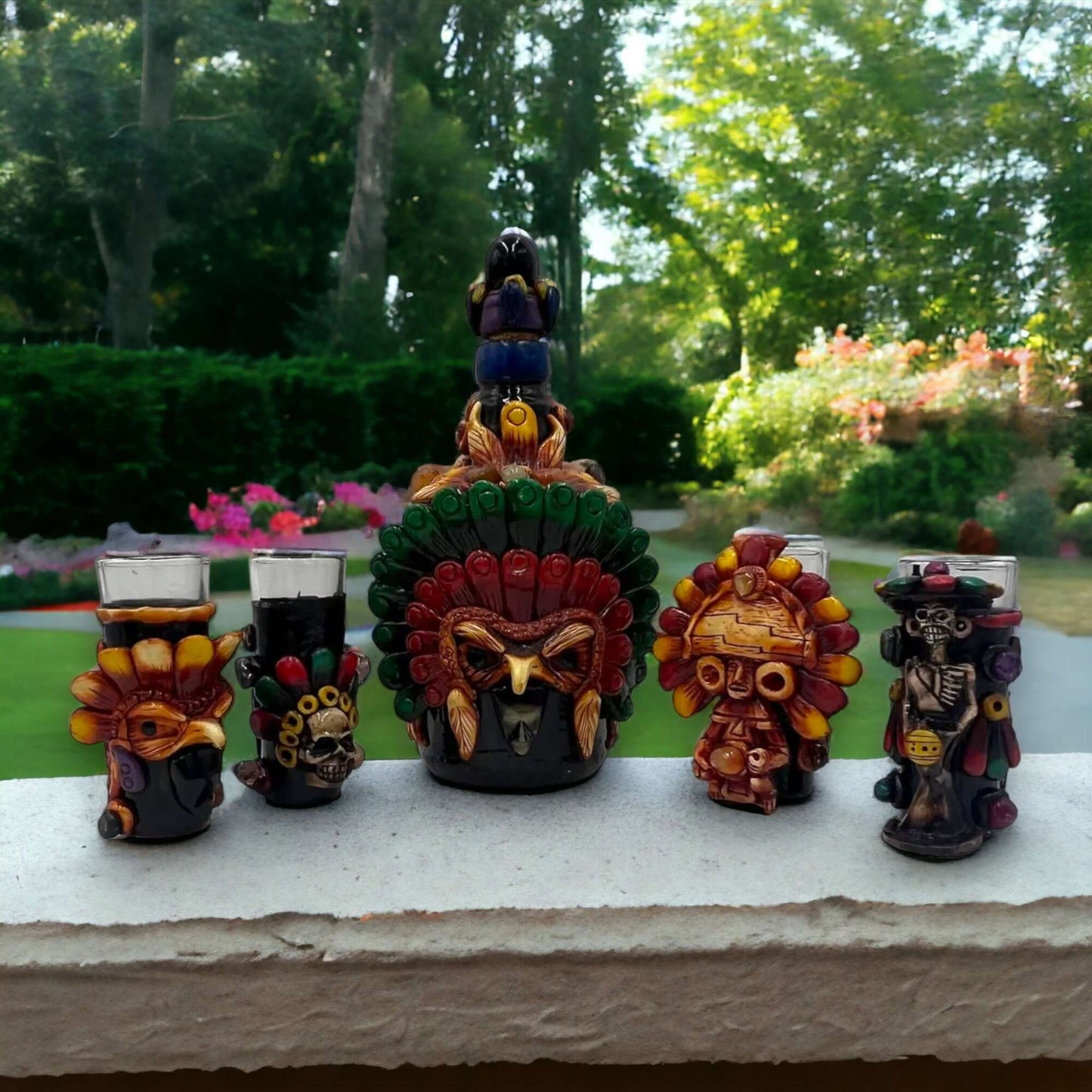 Mexican Shot Glass Set | Artisan Aztec Warrior Decanter Kit handcrafted colorful Aztec warrior decanter with matching shot glasses on outdoor ledge