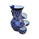 Blue and white Talavera fountain with floral patterns, tiered basins, and a decorative bird