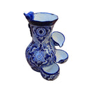 Side view of a blue and white Talavera fountain with floral ceramic detailing and three basins