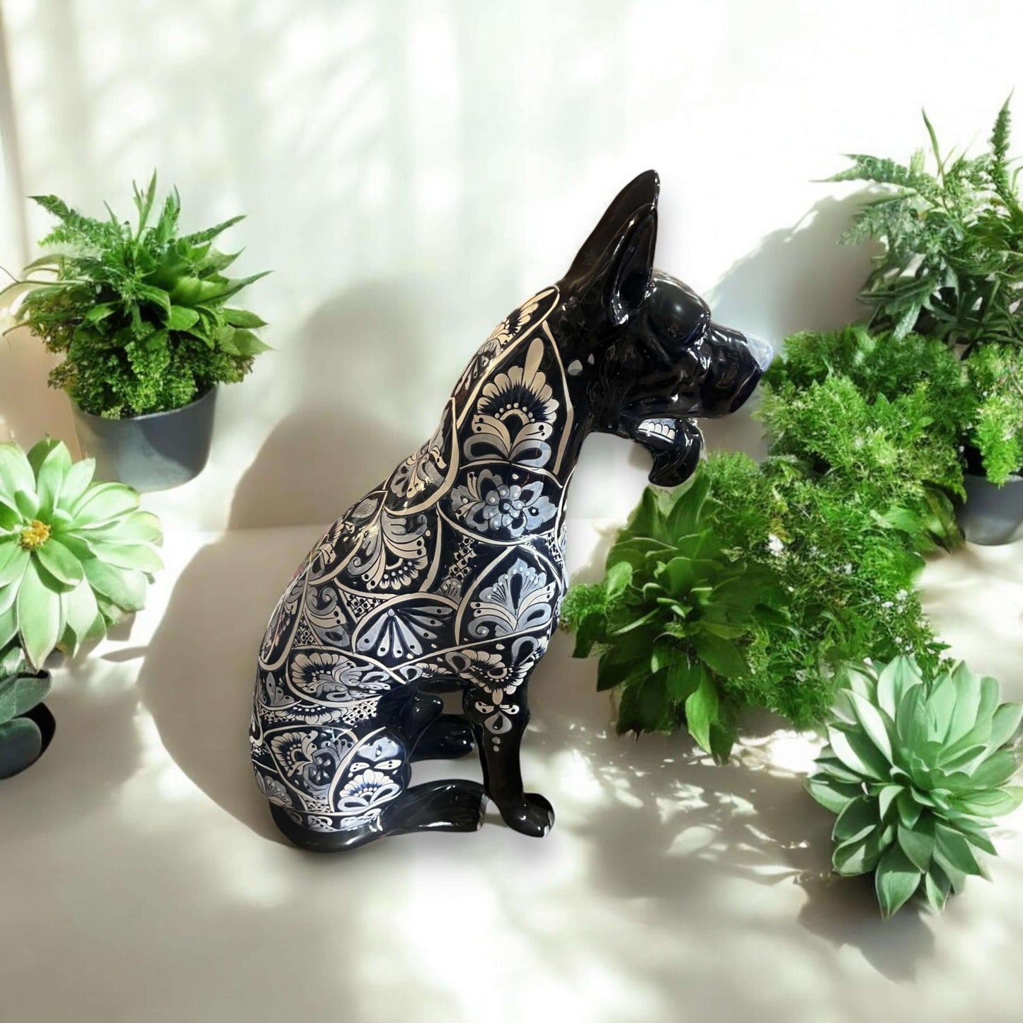 Blue & White Talavera Dog Statue | Handmade Ceramic Art - hand-painted Talavera ceramic dog with intricate blue and white patterns beside green succulents