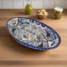 Talavera Oval Serving Platter | Blue & White Mexican Kitchenware hand-painted cobalt rim oval platter on wooden counter