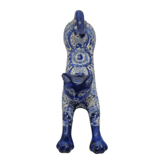 Profile view of a long blue and white Talavera stretching cat statue