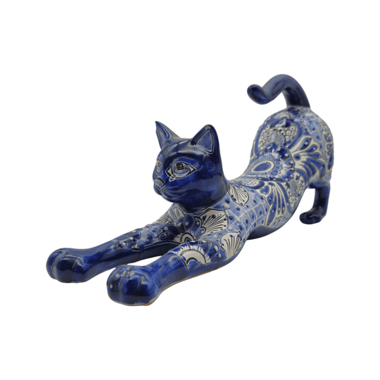 Front three-quarter view of a blue and white Talavera stretching cat statue