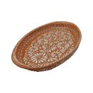 Angled view of a brown and white Talavera oval platter with floral border decoration