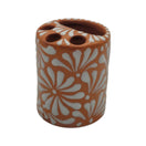 Front view of brown and white Talavera ceramic toothbrush holder with floral pattern