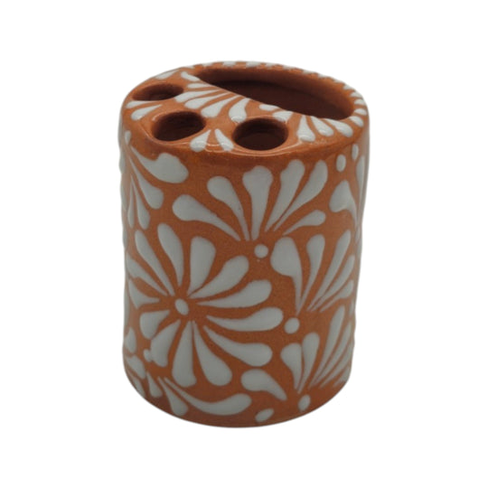 Front view of brown and white Talavera ceramic toothbrush holder with floral pattern