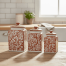 Brown and white Talavera canister set arranged on a kitchen counter