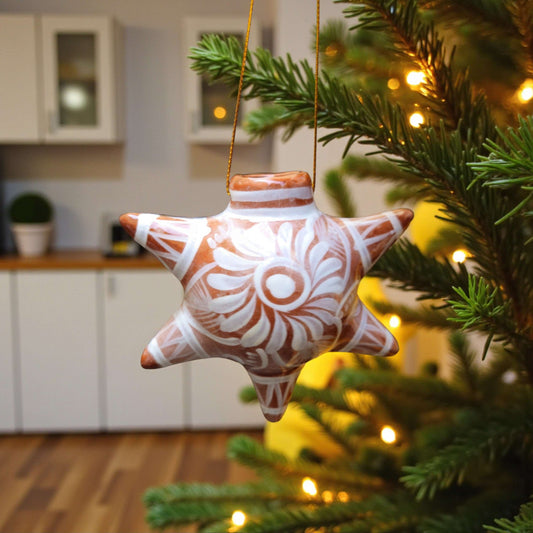 Brown & White Talavera Ornament | Star-Shaped Holiday Folk Art — hand-painted star ornament with brown base and white floral motifs hanging on Christmas tree